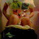 A girl records herself pooping as she sits on a toilet in a bathroom. Although you cannot see her face, the plopping sounds are clearly heard.